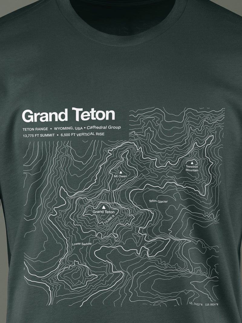 Topographic contour t-shirt of Grand Teton, Teton Range, Wyoming, 13,775 ft summit, rendered from USGS 3DEP elevation data. Cotton contour-art tee by Horizon Editions - real terrain, hand-drawn, no AI.